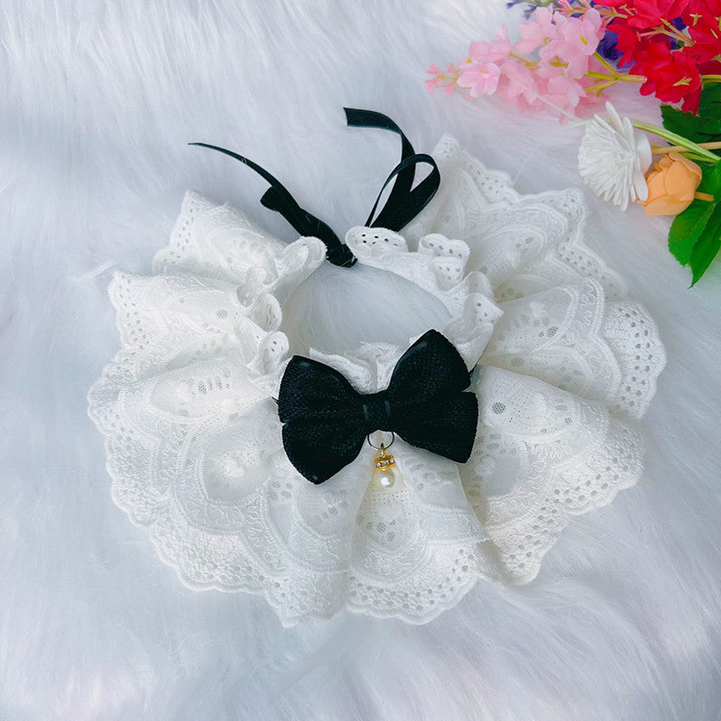 Black bow pet neckwear with white layered ruffles and pearl-look detail