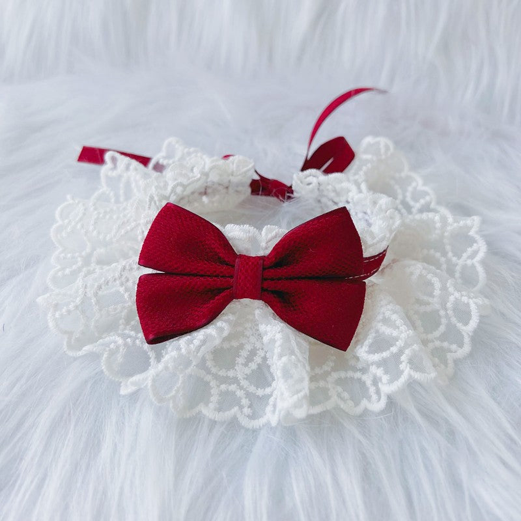 Burgundy pet neckwear with a centered bow and white ruffled lace-look edge