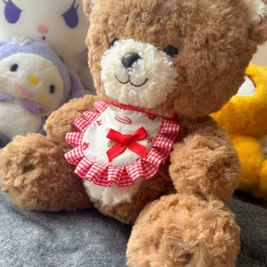 Red gingham pet neckwear displayed on a teddy bear
