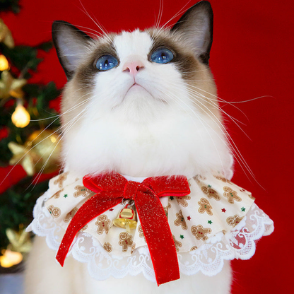 Gingerbread Bells cat neckwear worn by a cat beside a decorated tree