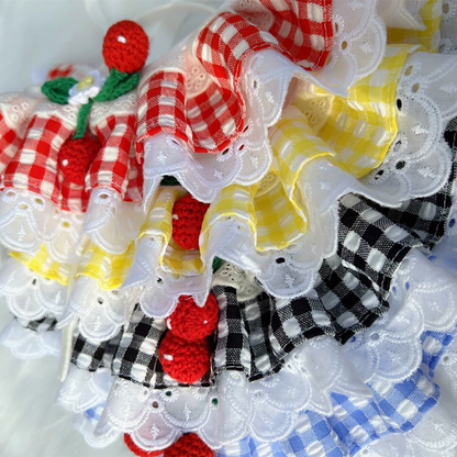 Multiple gingham pet neckwear styles layered together, showing ruffles and lace-look edging