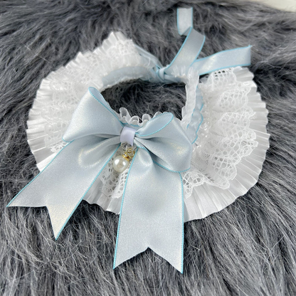 Blue bow pet neckwear with pleated white ruffles and a pearl-look charm