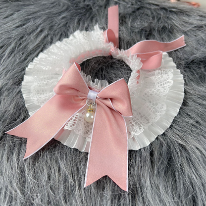 Pink bow pet neckwear with pleated white ruffles and a pearl-look charm