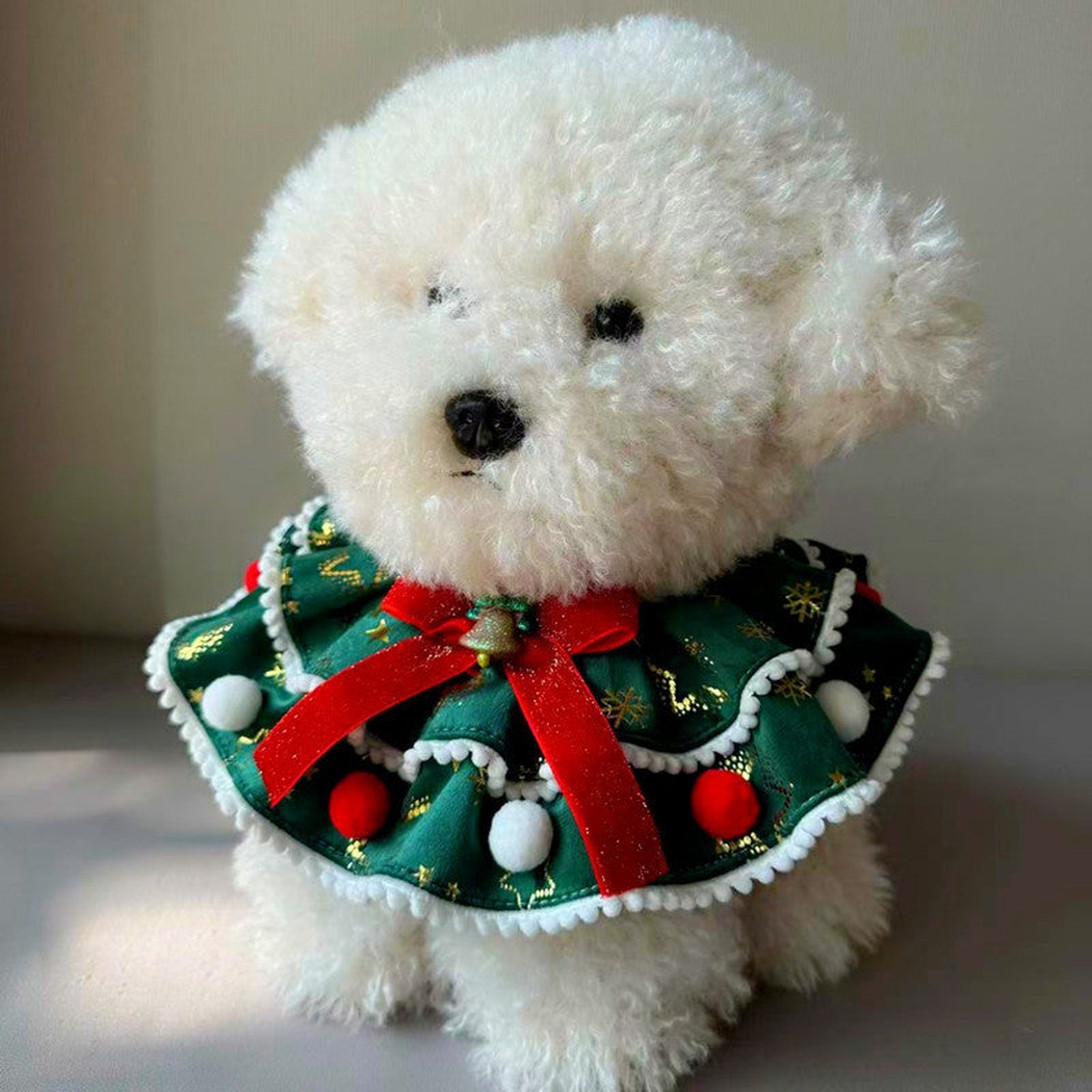 Dog wearing green Snowflakes pet neckwear with a red bow and layered trim