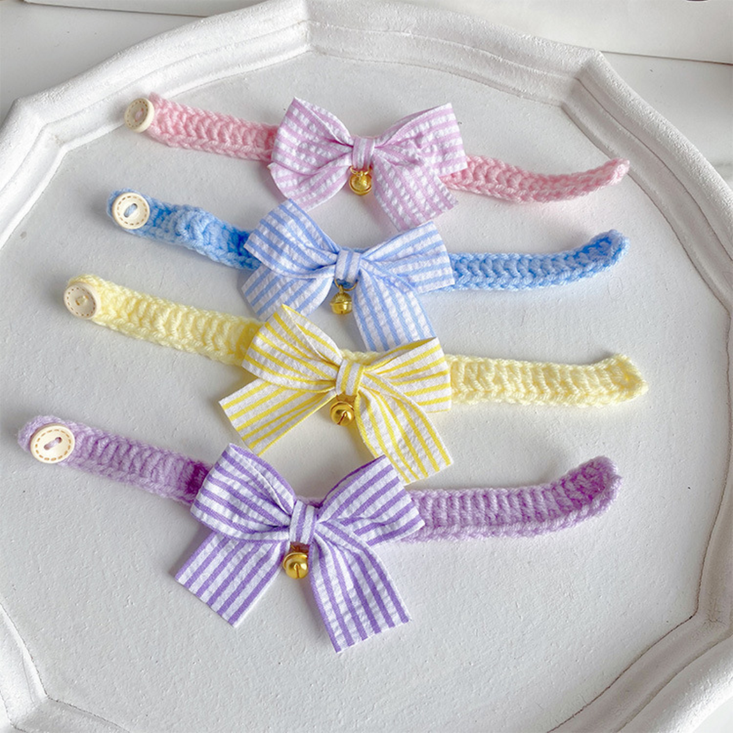 Yellow, blue, light purple and light pink cat collars with striped bows and bells