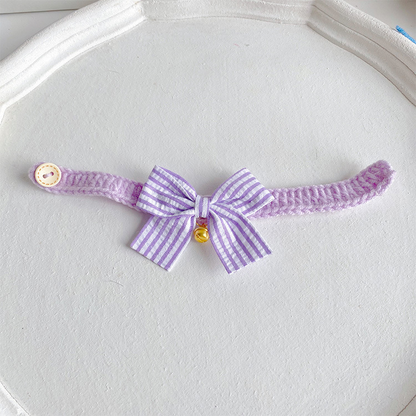 Light purple cat collar with striped bow and gold-tone bell