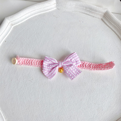 Light pink cat collar with striped bow and gold-tone bell