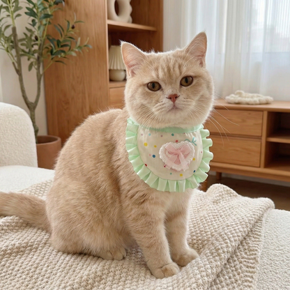 Light Green cat neckwear with mint ruffle, colorful dots and heart bow, worn by a cream cat indoors