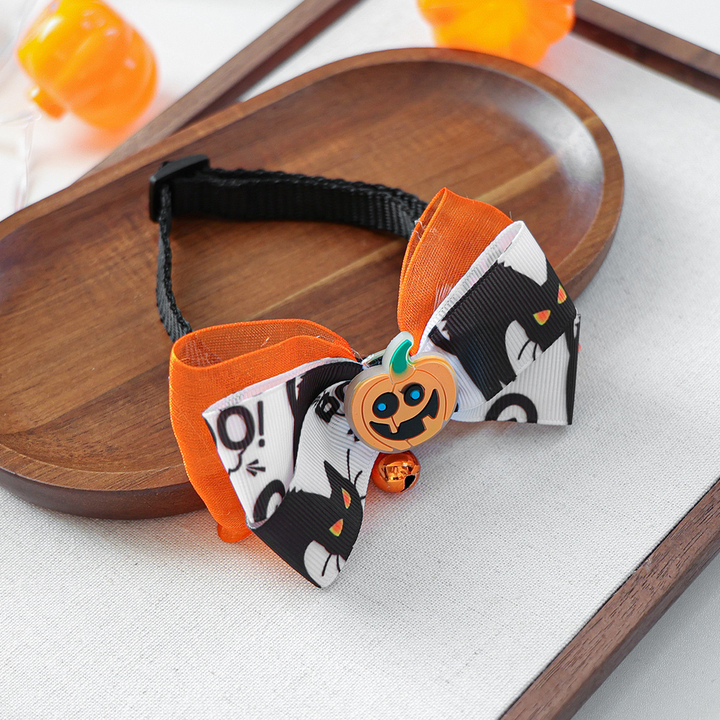 Overhead view of the cat-print bow pet neckwear and adjustable black neck strap