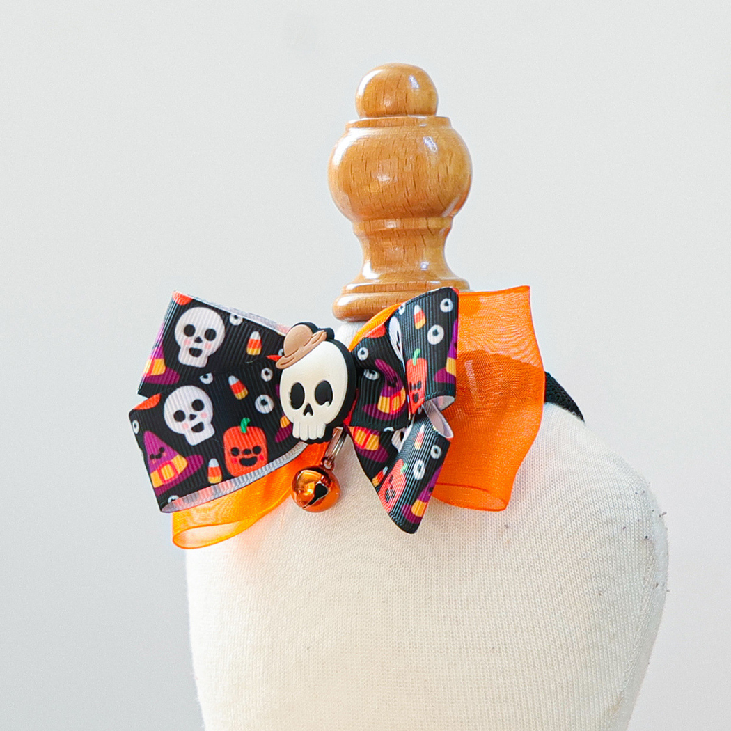 Angled view of the Hooded Skull bow layers, ornament and bell
