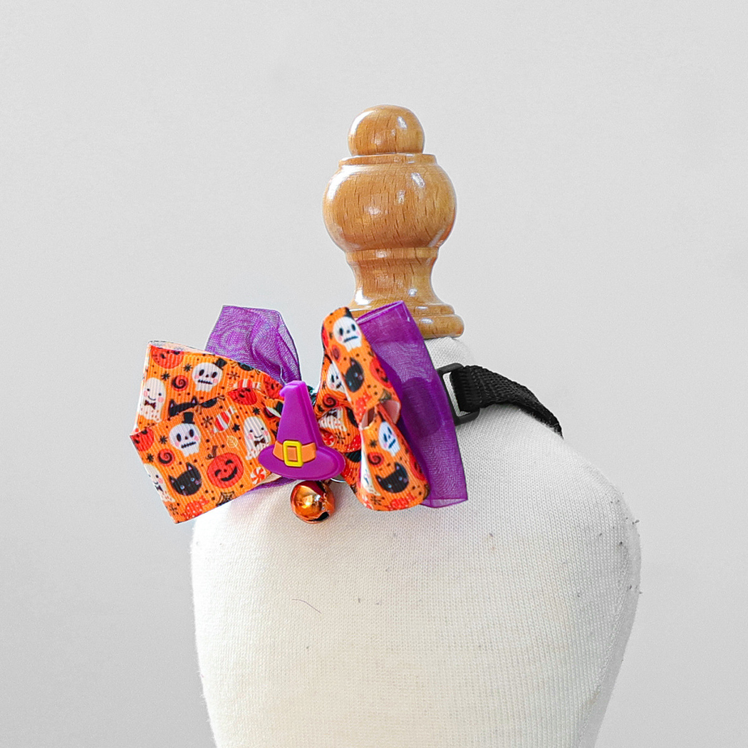 Angled view of the Witch Hat bow layers, ornament and bell