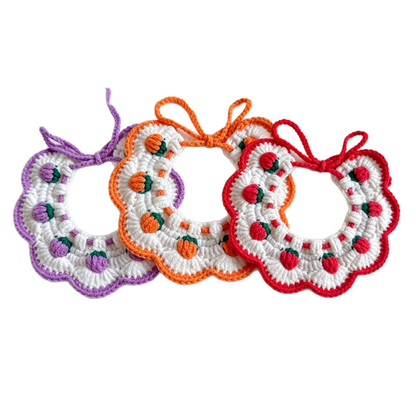 Purple, orange, and red floral bib-style pet neckwear displayed together
