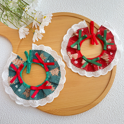 Red and green patterned pet neckwear with ribbon bows and white scalloped lace-look trim