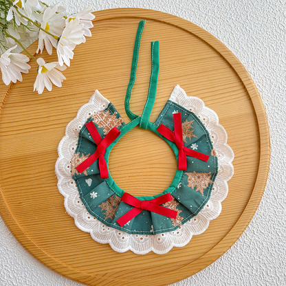 Green patterned pet neckwear with red ribbon bows and white scalloped lace-look trim