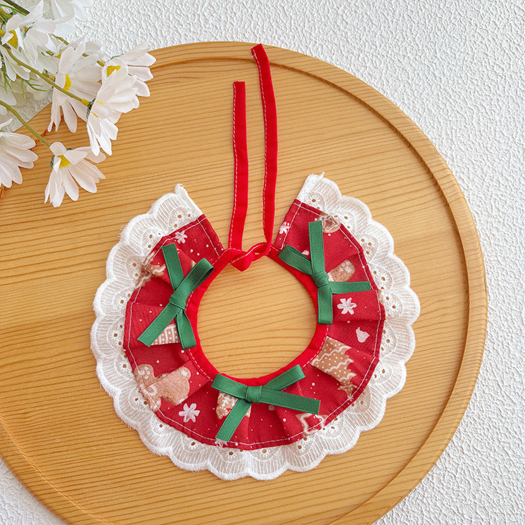 Red patterned pet neckwear with green ribbon bows and white scalloped lace-look trim