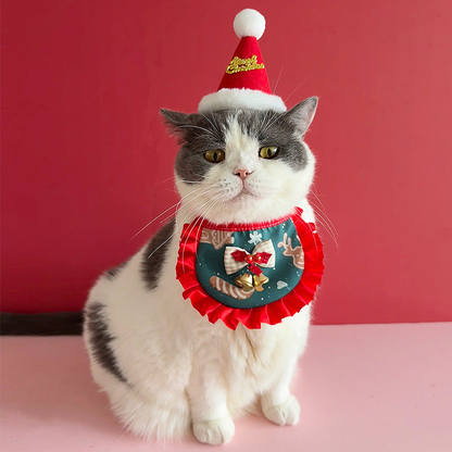 Gray and white cat wearing Reindeer pet neckwear with red ruffled trim and a bell bow