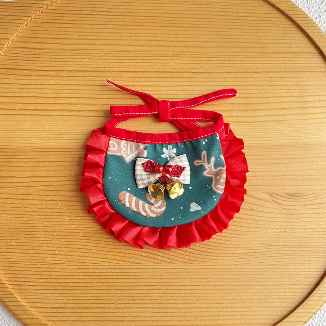 Reindeer pet neckwear with teal printed bib, red ruffled trim and bell bow
