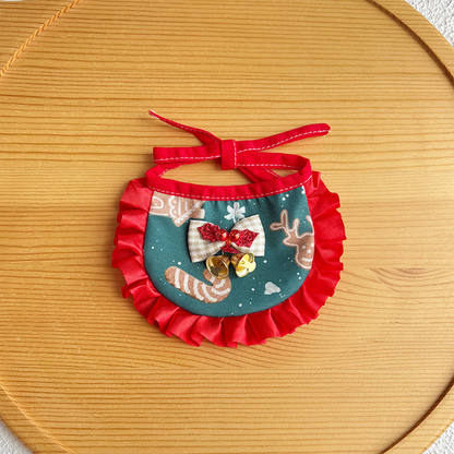 Reindeer pet neckwear with teal printed bib, red ruffled trim and bell bow