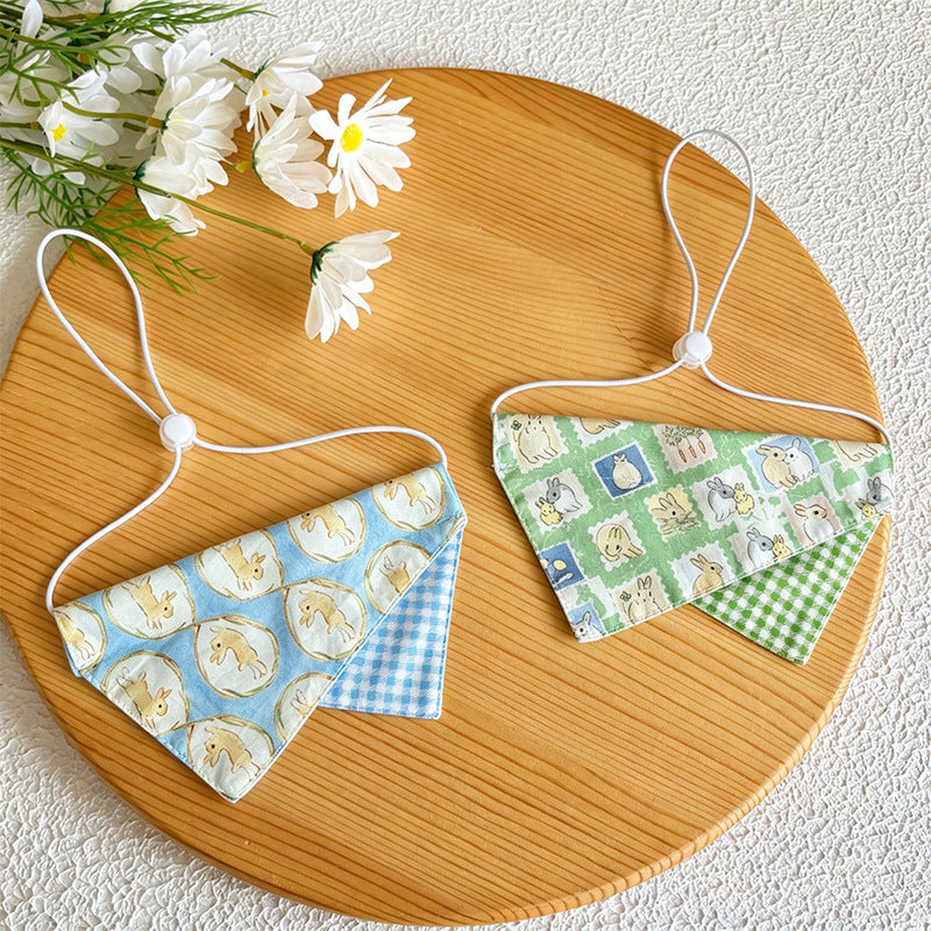 Light blue and green rabbit-pattern pet neckwear displayed together