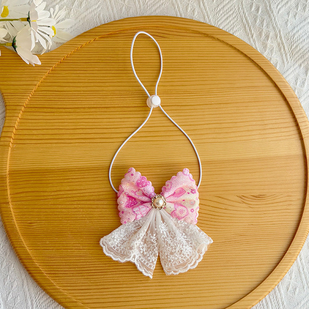 Pink bow pet neckwear with white lace-look tails and adjustable loop