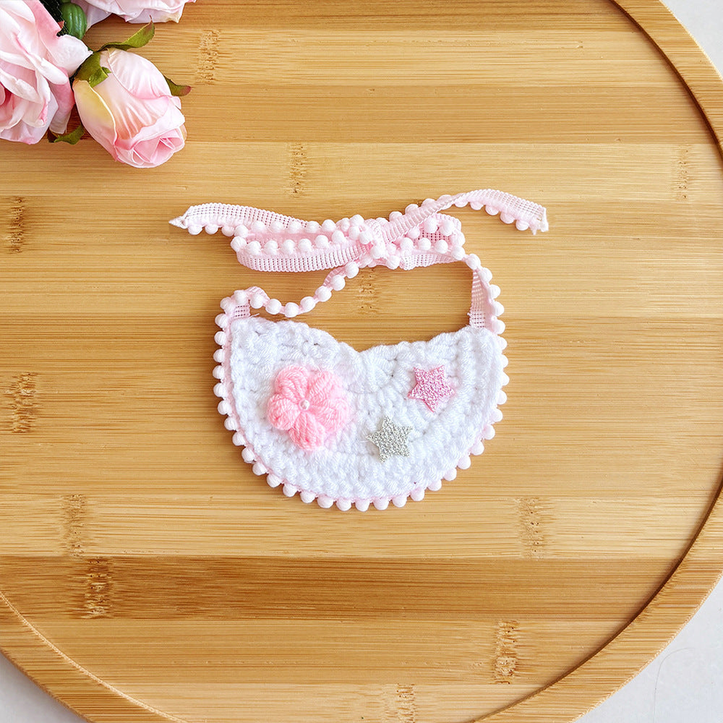Pink pet neckwear with flower and star accents, flat view