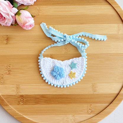 Light blue pet neckwear with flower and star accents, flat view
