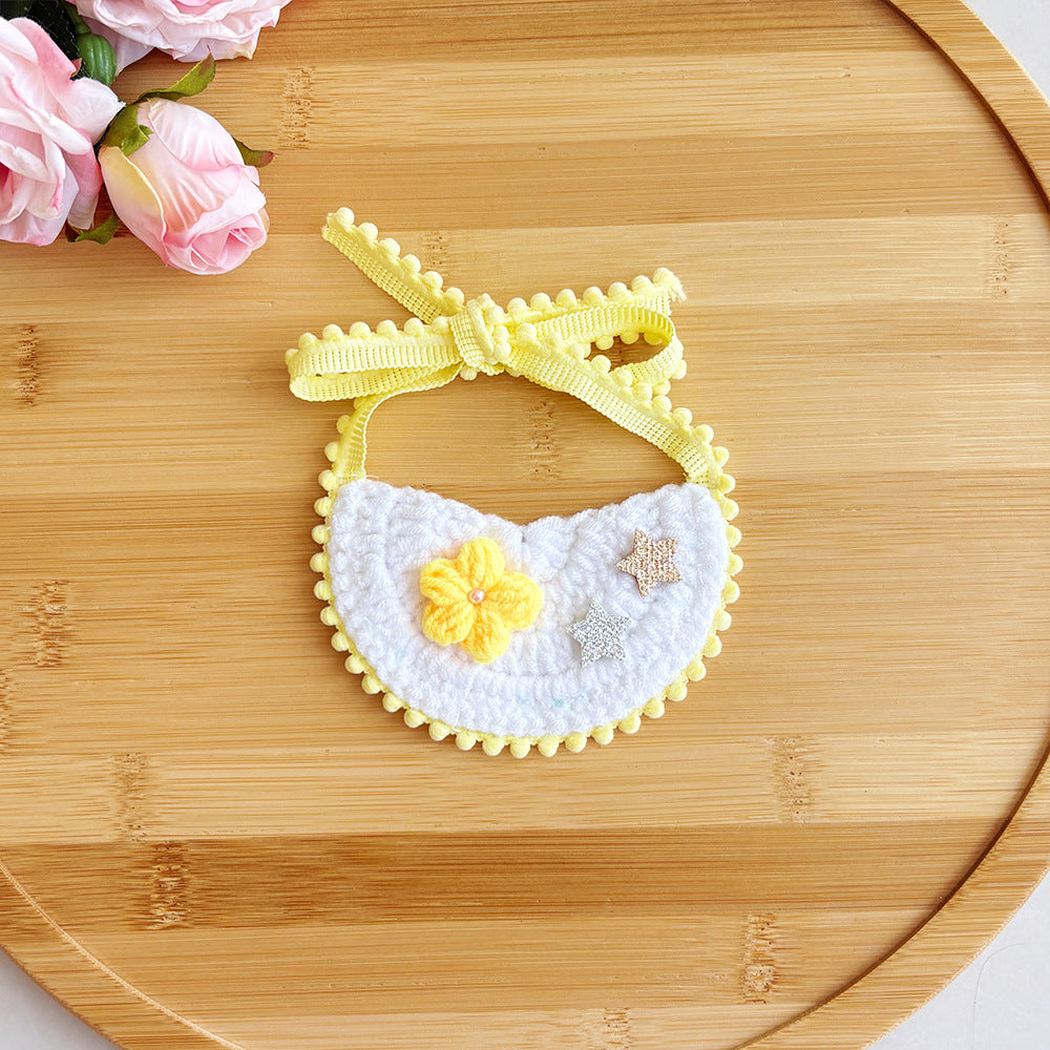 Yellow pet neckwear with flower and star accents, flat view