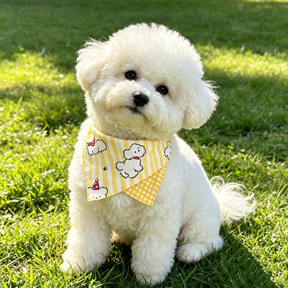 White dog wearing yellow dog-print pet neckwear outdoors