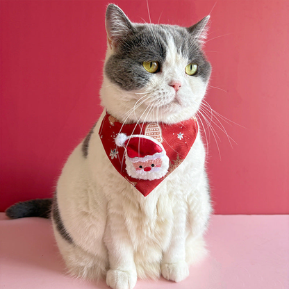 Cat wearing red Santa pet neckwear with a triangular front panel