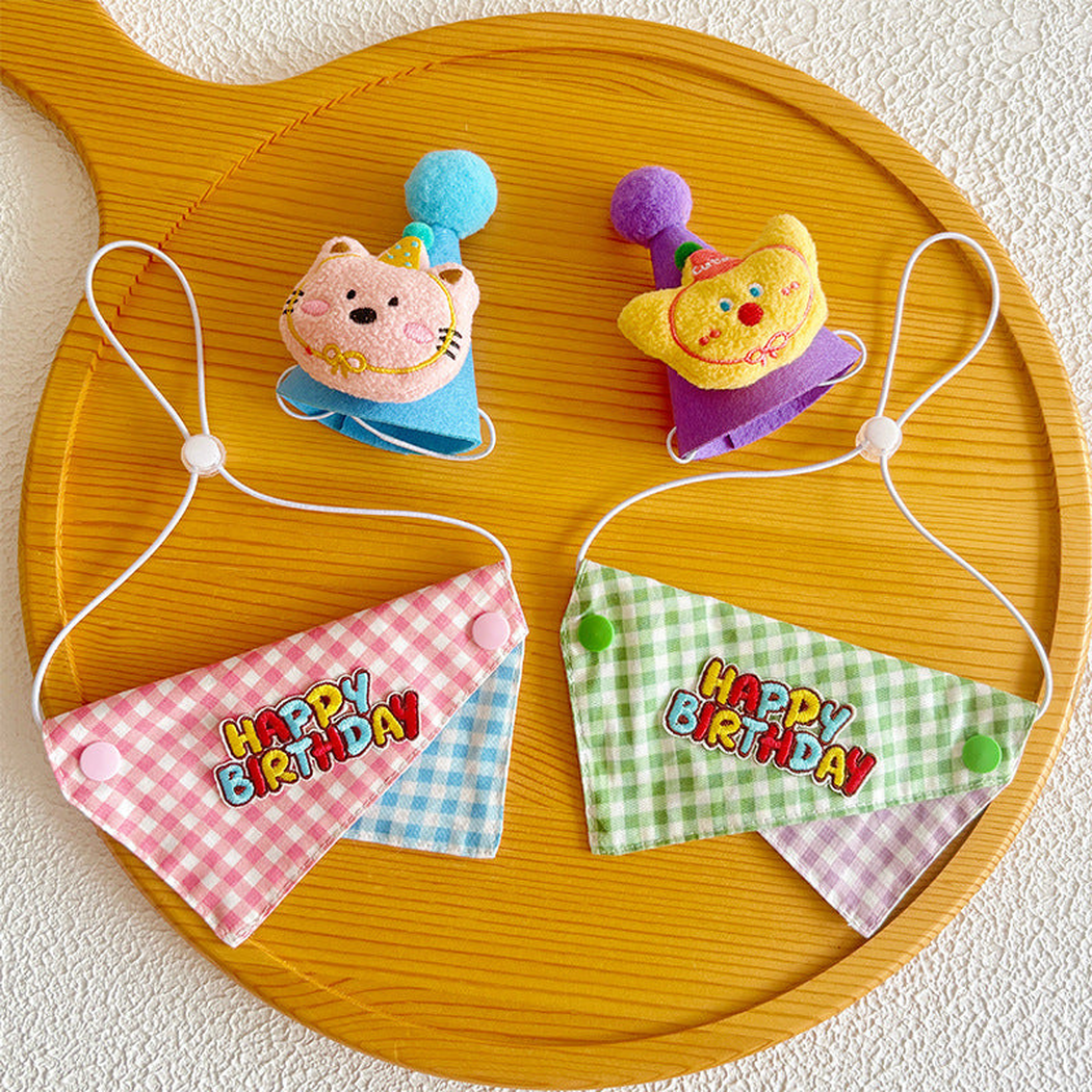 Overhead view of pink and green gingham bandanas with blue and purple character hats