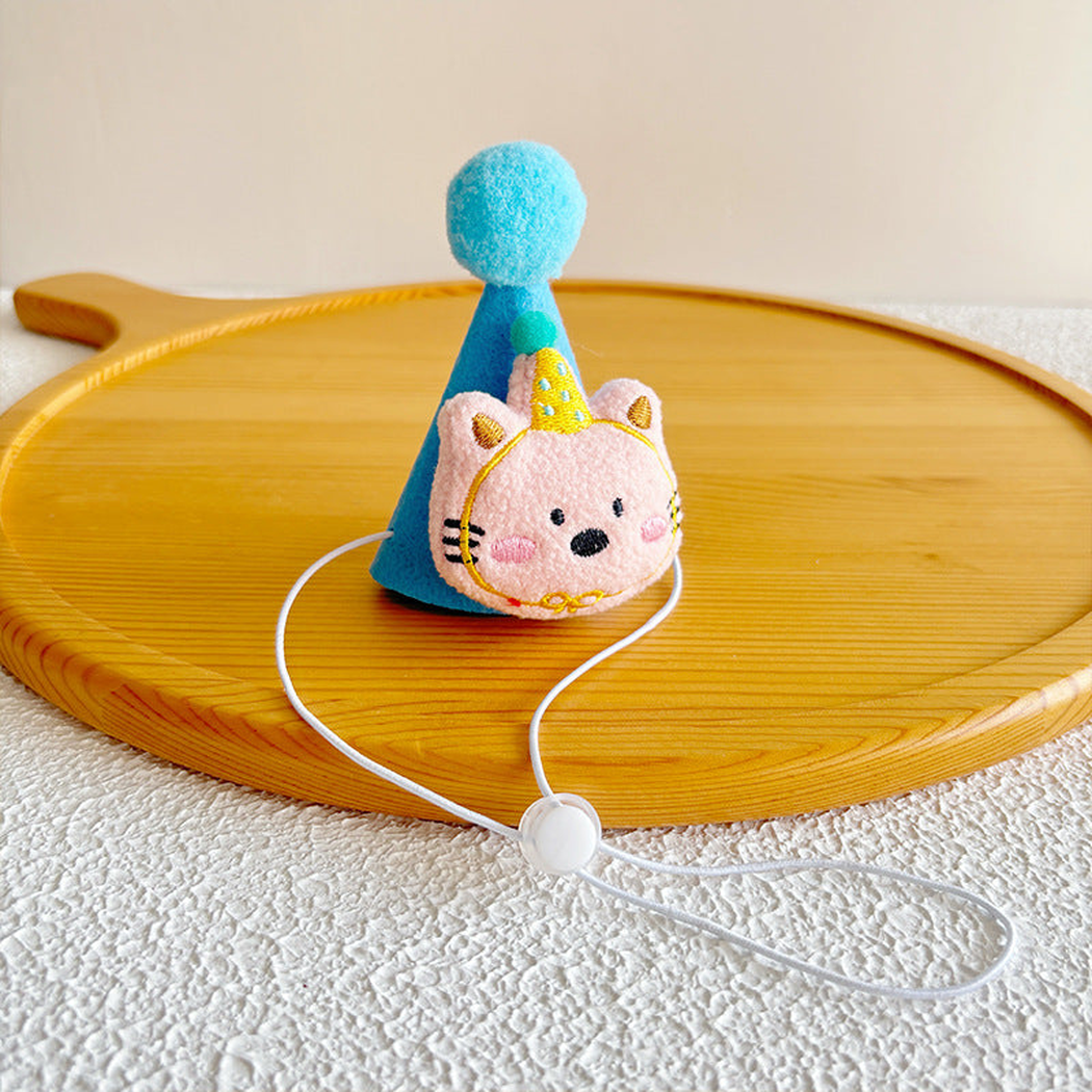 Blue Hat with pink cat-face decoration, top pom-pom and tie cord