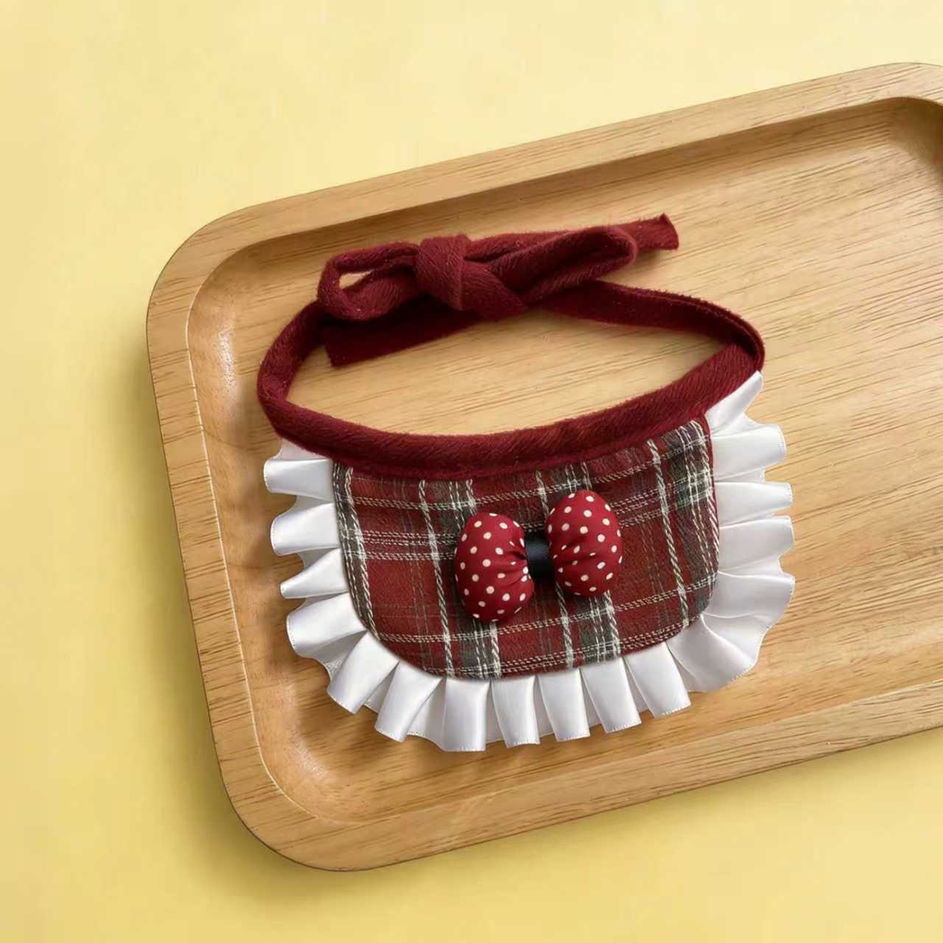 Bow style burgundy plaid pet neckwear arranged on a tray