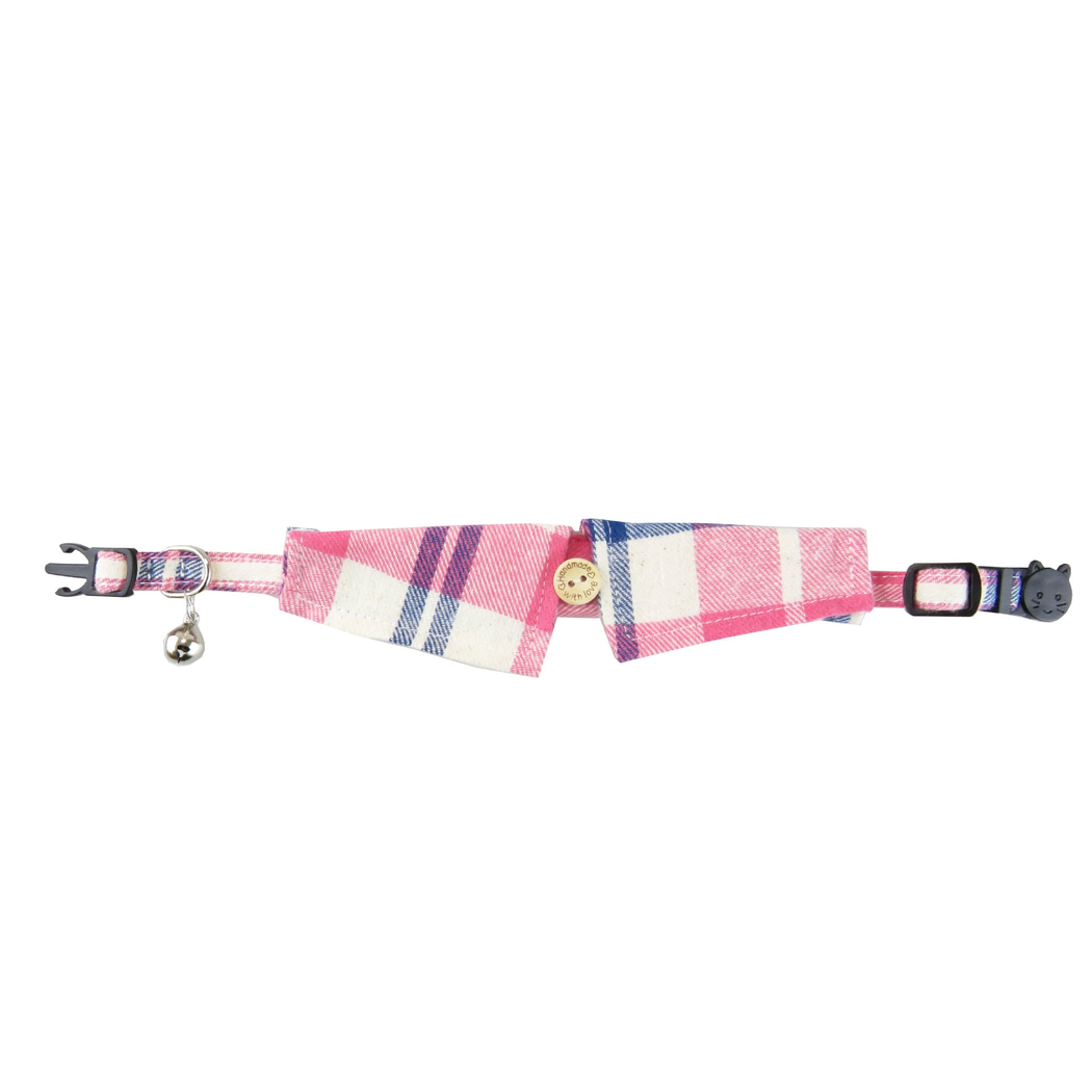 Pink, white, and navy plaid pointed cat collar laid flat with bell and buckle
