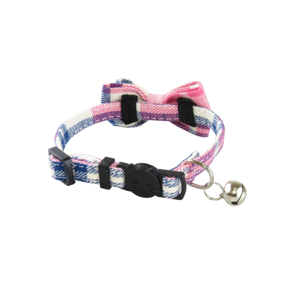 Close-up of the plaid cat collar buckle, bell, adjustment slider, and bow attachment