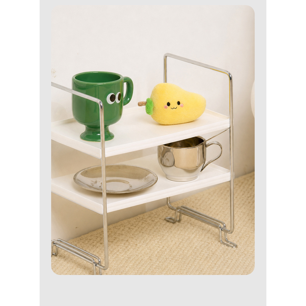 Mango character cat toy displayed on a shelf beside cups