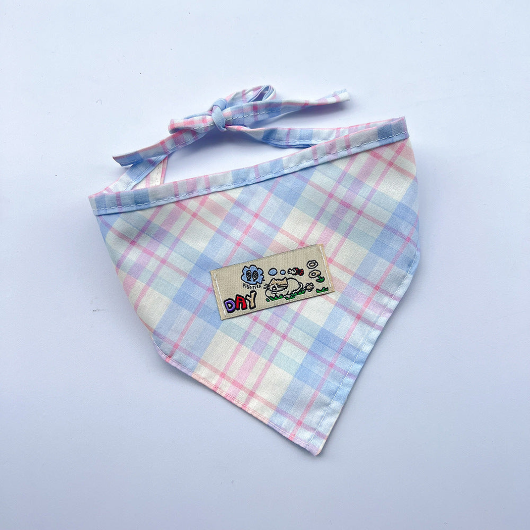 Blue / Pink plaid pet neckwear with tied straps and a rectangular cartoon patch.