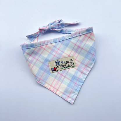 Blue / Pink plaid pet neckwear with tied straps and a rectangular cartoon patch.