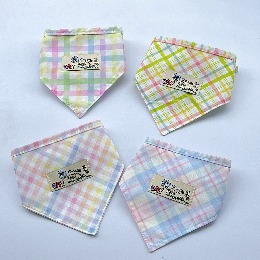 Four pet neckwear color variations arranged together, showing checked and plaid patterns with cartoon patches.
