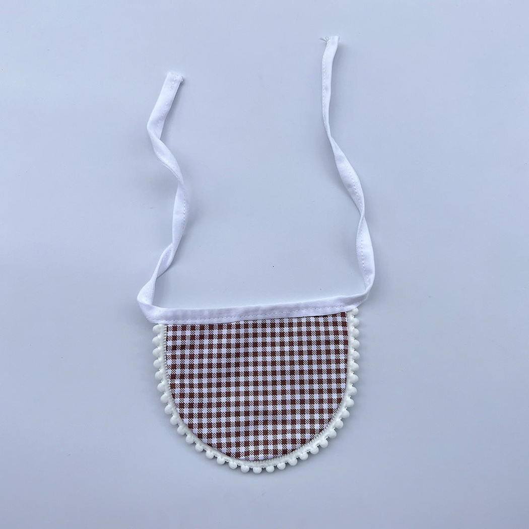 Brown gingham Pet Neckwear with white neck ties and pom-pom edging, laid flat.