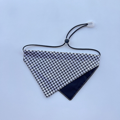 Black gingham Pet Neckwear with overlapping triangular panels and a round cord toggle.