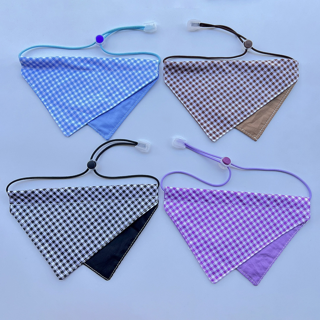 Blue, Brown, Black and Purple gingham Pet Neckwear arranged together on a pale blue surface.