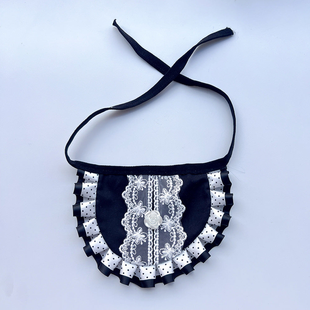 Black bib-style pet neckwear with white floral lace-look panel, rose-shaped ornament, and ruffled border