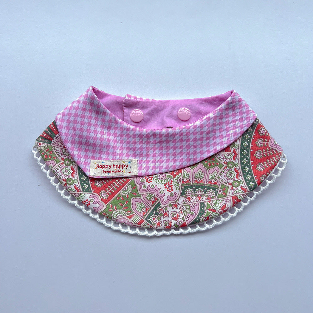 Pink pet neckwear with a gingham folded panel, floral pattern and white looped edging.