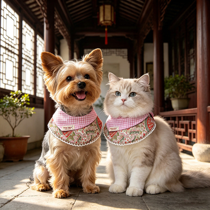 A dog and cat wearing pink gingham pet neckwear with floral bib panels.