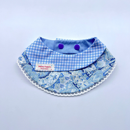 Blue pet neckwear with a gingham folded panel, floral pattern and white looped edging.