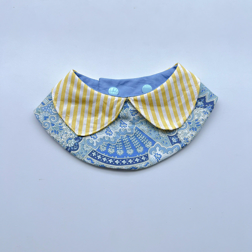 Yellow pet neckwear with striped rounded flaps over a blue floral bib panel.