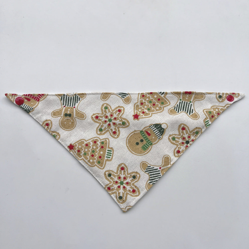 Ivory Bandana pet neckwear laid flat, with gingerbread figures, snowmen, trees, and red corner snaps.