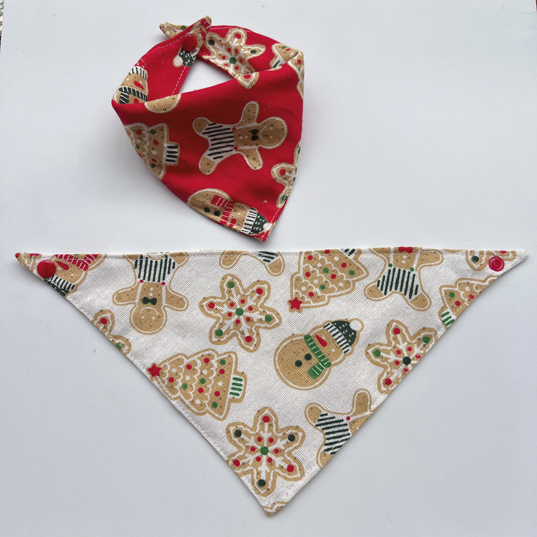 Red bandana pet neckwear fastened into a loop above an ivory bandana laid flat.