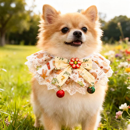 Dog standing in grass wearing Cream / Red Pet Neckwear, with a cream bow, printed ruffles and red and green dangling ornaments.