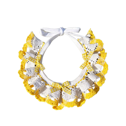 Yellow and white ruffled pet neckwear with gingham bows and white ties, displayed on white.